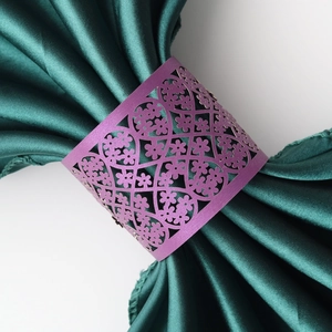 Detail showing purple pearlescent paper napkin ring with laser-cut floral pattern