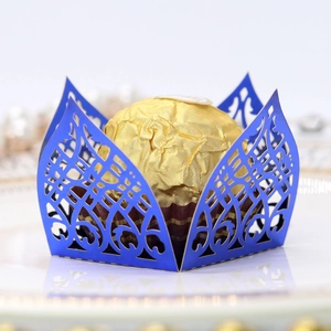 Macro shot of laser-cut blue mirror paper candy box with intricate floral patterns