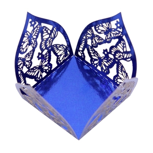Close-up of laser-cut hollow butterfly pattern on glossy blue metallic wedding favor box