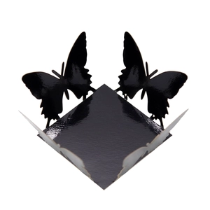 Close-up of laser-cut black mirror butterfly candy box with hollow lace details
