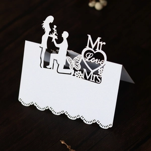 Detailed laser-cut white heart wedding place card featuring Mr Love Mrs silhouettes