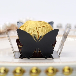 Detailed laser-cut black butterfly paper lace wrap for chocolate truffle decoration