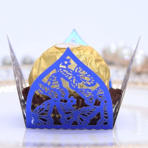 Detailed laser-cut butterfly favor box in blue with intricate hollowed patterns