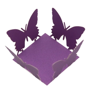 Detail of purple pearlescent paper butterfly cutout for cupcake toppers and gift boxes