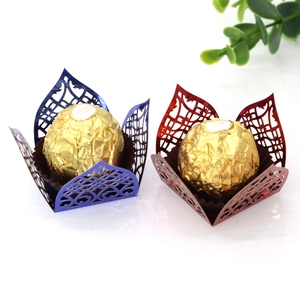 Detail of laser-cut hollow lace chocolate wrappers in navy blue and burgundy colors