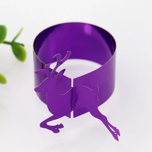 Detail of purple metallic reindeer napkin ring with reflective finish for festive decor
