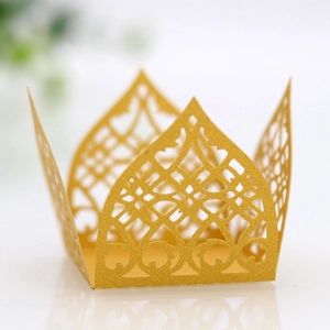 Detail of laser-cut crown pattern on pink pearlescent paper candy box for wedding decor