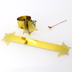 Detail showing golden snowflake napkin rings in flat and rolled festive table settings