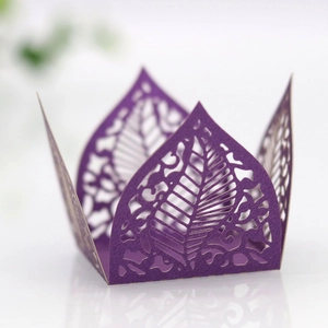 Macro detail of laser-cut purple paper cupcake wrapper with elegant leaf vein patterns
