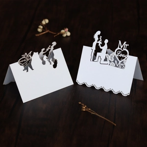 Detail showing laser-cut wedding place cards with Mr Love Mrs text and silhouettes