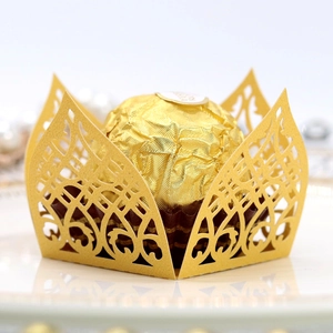 Laser-cut gold paper chocolate wrapper with intricate floral lace for wedding favors