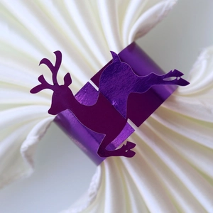 Detailed close-up of a purple reindeer napkin ring made of metallic reflective paper
