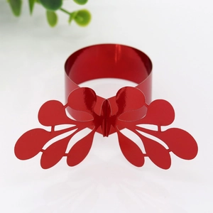 Close-up of laser-cut red glitter butterfly napkin ring for wedding table decor