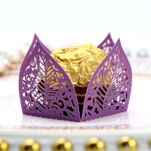 Detailed laser cut purple paper chocolate wrapper with intricate leaf pattern and hollow design