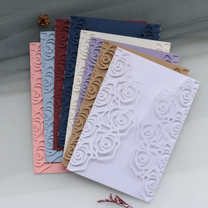 Laser-cut rose flower wedding invitations in diverse colors with textured paper finish