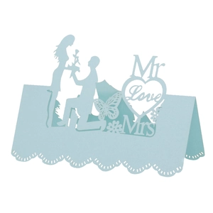 Laser-cut light blue wedding place card featuring hollow heart and romantic silhouettes