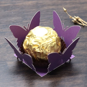 Macro detail of laser-cut butterfly hollow candy box in purple pearlescent paper