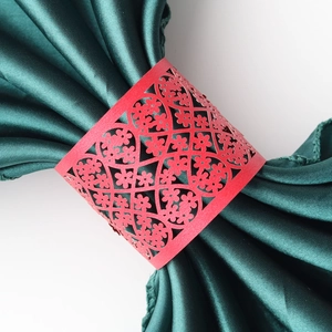 Detail showing the red laser-cut lace heart pattern on pearlescent paper napkin ring
