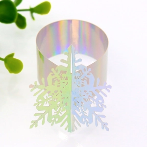 Close-up of laser-cut iridescent snowflake paper napkin rings for Christmas table decor