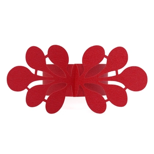Detail of red laser-cut paper napkin ring with elegant hollow floral butterfly pattern