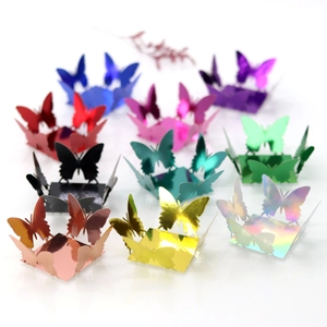 Detailed macro of 3D mirror gold butterfly candy boxes in various metallic colors