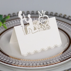 Detail of laser-cut white heart place card with 3D proposal silhouette and butterfly design