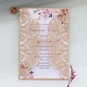 Detail of laser-cut rose wedding invitation set with elegant floral inner card