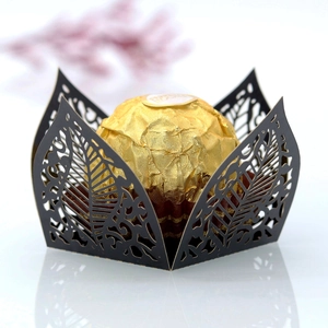 Detail of laser-cut black cardstock chocolate wrapper with symmetrical leaf patterns