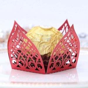 Macro view of laser-cut red paper candy box featuring intricate geometric floral hollows