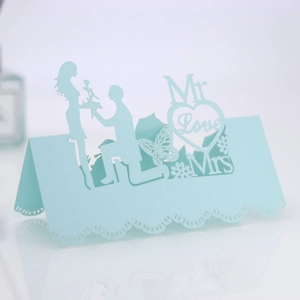 Detail of laser-cut wedding place card with pearlescent finish and Mr Love Mrs motifs