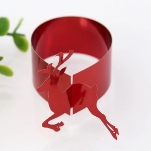 Detail of red mirror deer paper napkin rings for elegant Christmas table setting décor