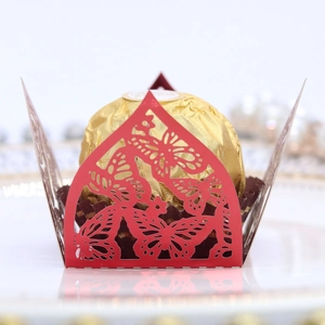 Detail of red laser-cut butterfly chocolate holder with elegant hollowed pattern