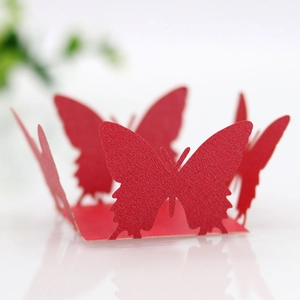Detailed laser-cut texture of red pearlescent paper butterfly favor box decoration