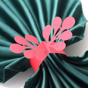 Macro view of laser-cut red paper napkin ring with elegant hollow lace pattern