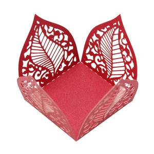 Detailed laser-cut hollow leaf patterns on a festive red paper gift box for chocolates