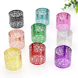 Detailed macro view of hollow flower pattern on nine multi-colored metallic napkin rings