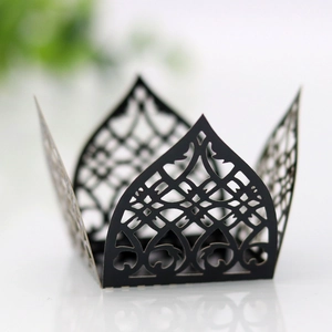 Detail showing laser-cut black lace cupcake wrappers with elegant vine patterns