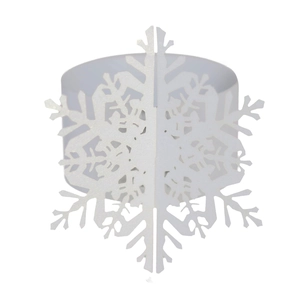 Macro detail of white pearlescent paper napkin ring featuring a hollow snowflake design