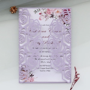 Detail of laser-cut rose hollow pattern on light purple pearlescent wedding invitation