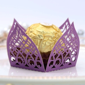 Macro shot of laser-cut purple pearl paper chocolate box with vintage lace pattern