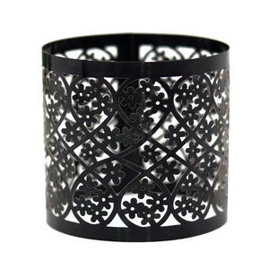 Detail of laser-cut hollow lace pattern on black matte metal cylinder ring