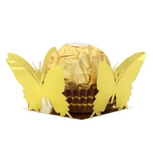 Laser cut yellow butterfly candy box with a gold foil chocolate on a white background