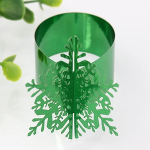 Detailed view of glossy green snowflake napkin ring with intricate cutout design