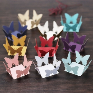 Macro shot of 3D laser-cut butterfly paper favor boxes in assorted vibrant colors