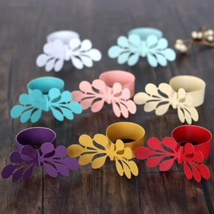 Detail of laser-cut paper napkin rings in diverse colors with lace floral patterns