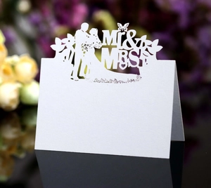 Laser-cut white wedding place card featuring Mr & Mrs silhouettes and butterfly details