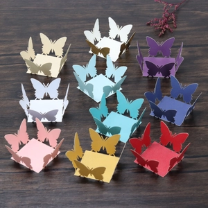 Detailed laser-cut paper butterfly decorations in assorted colors for cupcake wrapping
