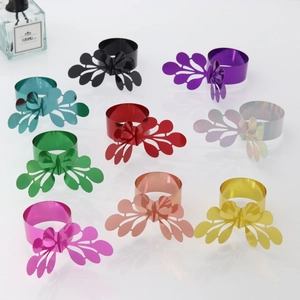 Macro detail of laser-cut petal napkin rings shown in nine metallic vibrant colors
