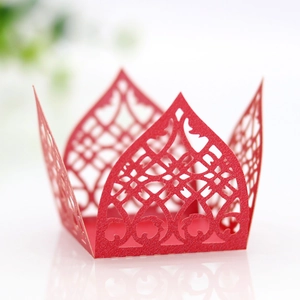 Macro detail of laser-cut red lace paper favor box with intricate floral hollow pattern