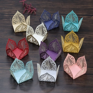 Detailed laser-cut paper chocolate box with intricate leaf patterns in multiple colors